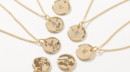 A group of gold birthstone necklaces