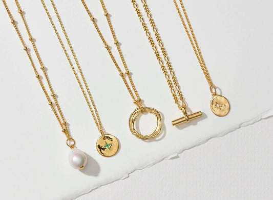 Collection of meaningful necklaces in gold