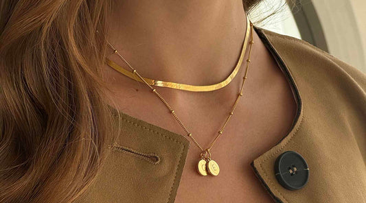 mum wearing a gold necklace with her two children's initials