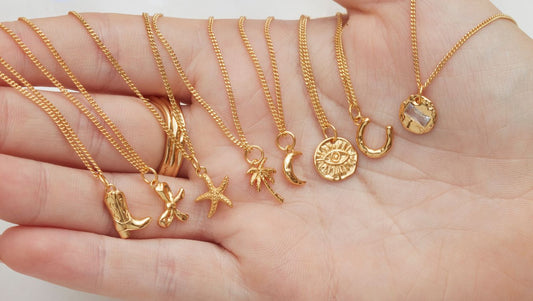 A line up of meaningful gold vermeil necklaces