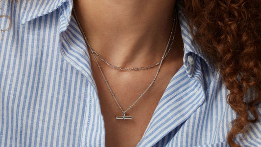 layered silver necklace on a model