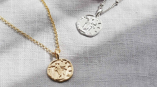 2 coin necklaces, one in silver and one in gold